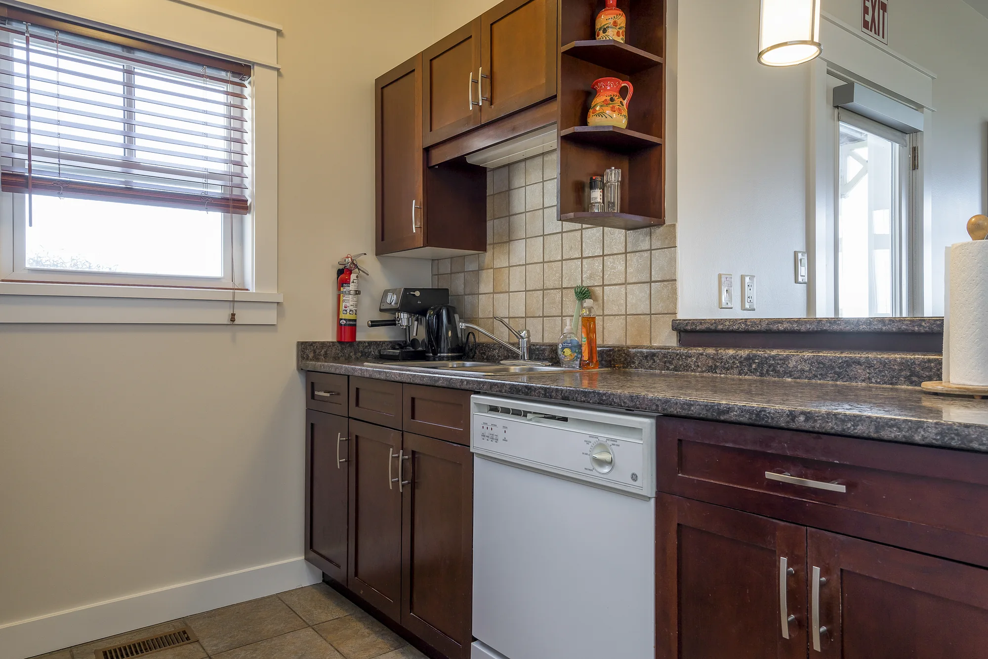 Kitchen with cabinets, counter, and dishwasher