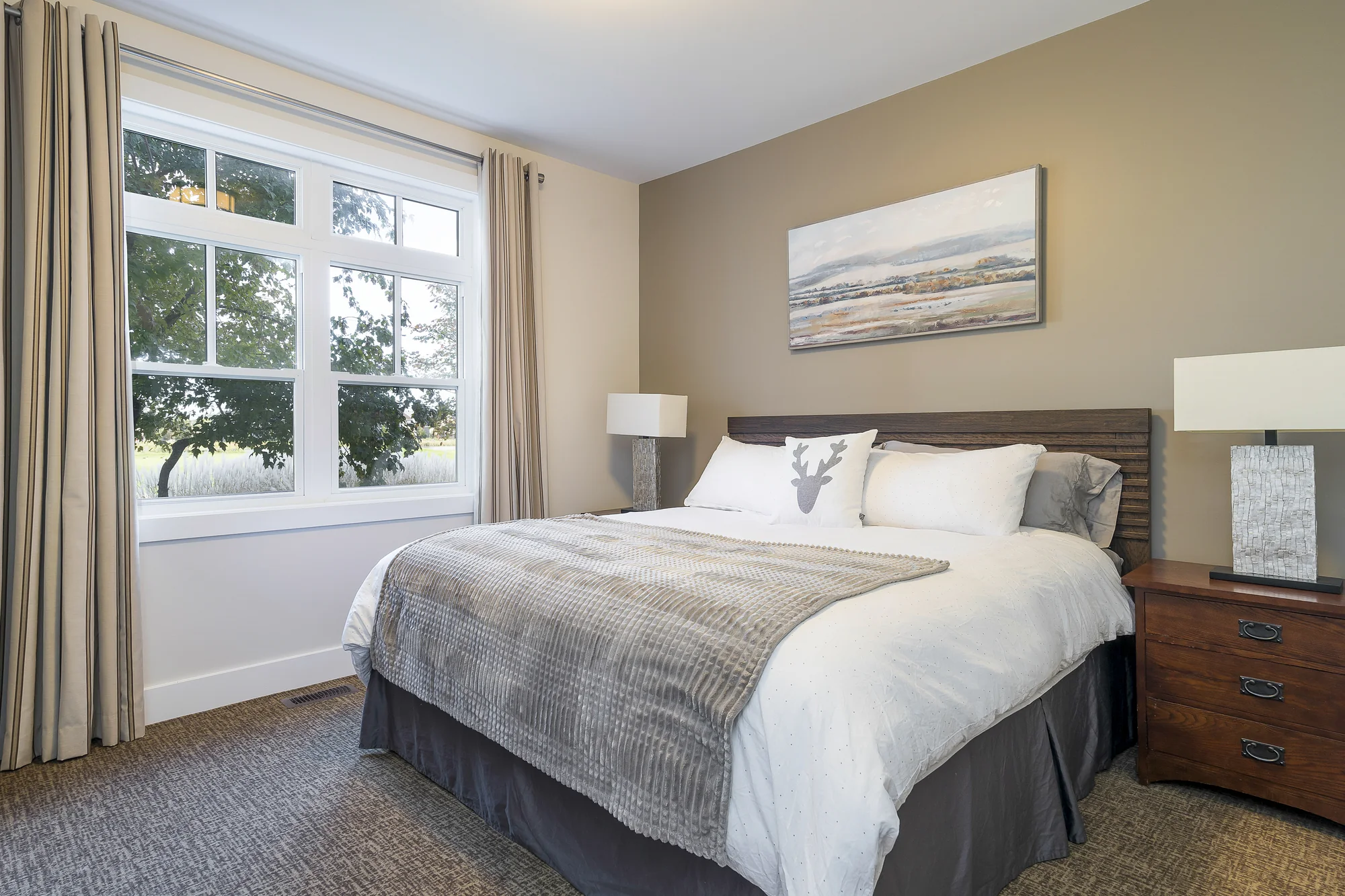 King bedroom with bright windows